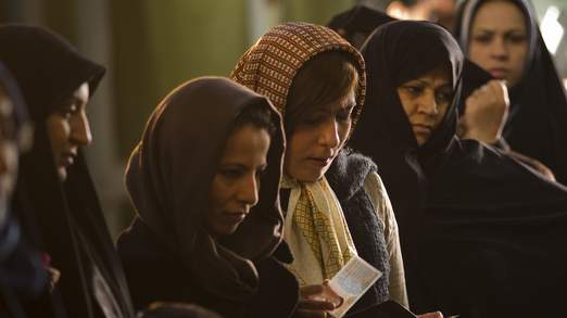 Women wait in line to vote for the parliamentary election in a mosque in south Tehran